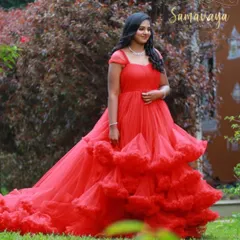 The full volume of this red frill gown is on display here. Renting allows you to wear a dramatic dress like this just for your shoot.