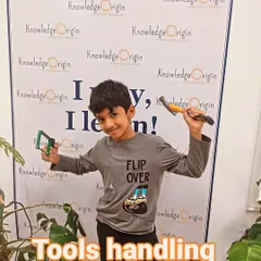 A proud student shows off the tools he's learned to handle. We empower kids with practical skills and the confidence to use them.