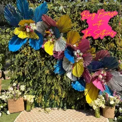 We love bringing a modern, playful twist to traditional festivals. For this Holi party, we designed a vibrant photo backdrop using colorful dried palm leaves and fresh flowers, creating the perfect spot for guests to capture the joy of the celebration.