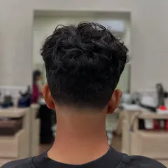 The view from the back showcases the flawless graduation of the taper fade. We focus on creating a smooth blend that grows out well, whether you have straight or curly hair.