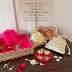 My Rakhi hampers are a complete celebration in a box. This one includes a Rakhi and Lomba set, a beautiful resin thaali, and a selection of gourmet treats, all thoughtfully arranged to honor the special bond of siblings.
