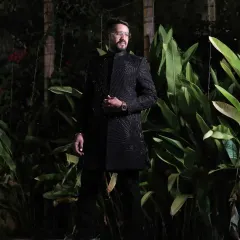 A client ready for his evening event in a fully embroidered black sherwani. The tone-on-tone detailing creates a look that is both luxurious and understated.