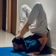 A deep backbend, placing the feet on the head. This level of flexibility comes from years of dedicated practice in heart-opening and spinal mobility.