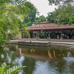 This is the first view that greets you, our Pond Pavilion beside the serene kalyani. The calm water and ancient trees create a sense of peace, a perfect welcome to the property.