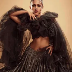 An editorial look featuring smoky eyes and a contoured face, paired with a dramatic black tulle outfit. The makeup adds to the moody and high-fashion aesthetic of the shoot with Adline Castelino.
