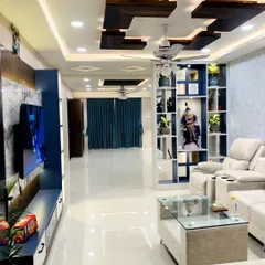 Here is a complete living and dining area I designed, focusing on a luxurious and open feel. Notice the layered false ceiling with wooden accents and integrated lighting, which creates zones and adds warmth, a key Vastu element for family spaces.