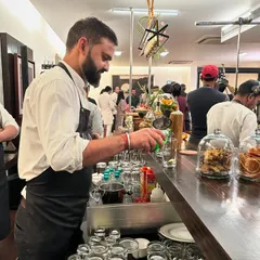 Our bartender crafts a refreshing drink at a bespoke bar setup. This behind the scenes shot from the 'Fabulous Lives of Bollywood Wives' event showcases our full service capabilities, including professional mixology.