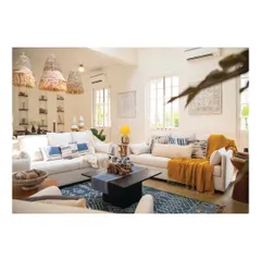 This living room in a Goa holiday home was designed to be a peaceful retreat from city life. We used a palette of whites, blues, and yellows with natural materials like jute and wood to create a bright, airy space that invites you to unwind and reconnect with nature.