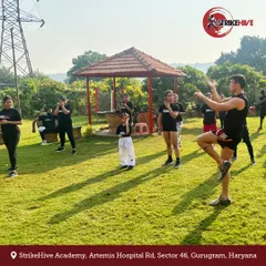 An instructor leads an outdoor training session in a park. Taking our practice outside allows for different types of drills and adds an element of adventure to our training regimen.