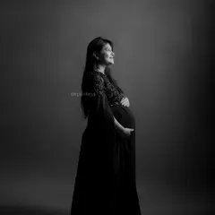 A dramatic and elegant black and white portrait, using lighting to create a hopeful and forward-looking mood.