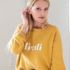 This is a perfect example of lifestyle photography. The model in a casual sweatshirt, captured in a natural, relaxed pose, helps customers connect with the brand's comfortable and effortless vibe.