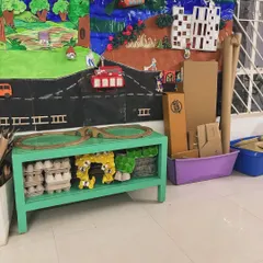 A shelf that once held toys is now filled with egg cartons and cardboard boxes. This setup is an open invitation for children to build, design, and invent, proving that creativity doesn't require new or shiny things.