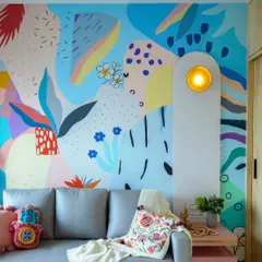 This room is designed to spark instant joy. The vibrant, abstract wall mural by a collaborating artist becomes the stunning centerpiece of this fun and energetic space.