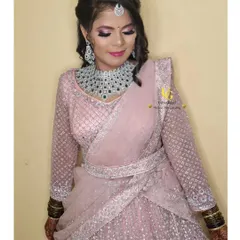 Shruthi looking stunning in her sparkling pink lehenga. The belted dupatta adds a contemporary touch to her reception outfit.