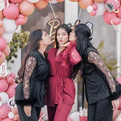 A sweet moment from the bachelorette party, with the bride-to-be getting kisses from her best friends.