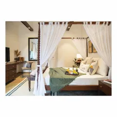 For this tropical-themed bedroom, we designed a classic four-poster bed with soft, buttery curtains to create a dreamy, resort-like feel. The design includes a matching study desk and bedside tables, all crafted from solid wood.