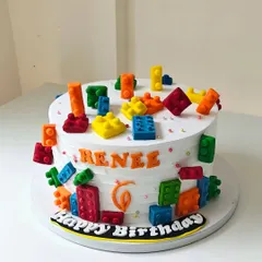 Building a fun birthday with this Lego-themed cake. It's covered in colorful, edible Lego blocks made from fondant, creating a playful and interactive dessert that kids absolutely love.