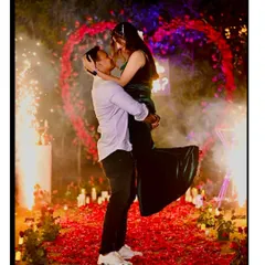 A magical proposal moment captured perfectly. I created this romantic outdoor setting with a heart-shaped arch of red flowers, a candle-lit pathway, and cold pyro for that extra spark.