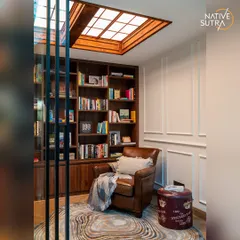 We designed this personal library to be a cozy escape. It features floor-to-ceiling wooden bookshelves, a comfortable leather armchair, and a large skylight that floods the space with natural light, making it perfect for reading.