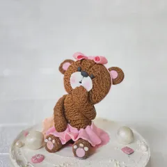 A close-up of our handmade teddy bear topper. We carefully sculpt each detail, from the textured fur to the sweet expression, to create a truly special centerpiece.