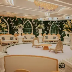 Another view of the serene and elegant decor. I designed this space with a green and white floral wall, classic furniture, and clean lines to prove that sometimes simplicity creates the most magical moments.
