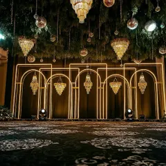 This is what we mean by 'Met Gala style'. For this Sangeet, we designed a modern, architectural backdrop with clean neon arches and dramatic crystal chandeliers, setting the stage for a high-energy night of glamour and celebration.