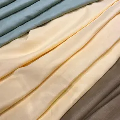 The soft drape and subtle colors of our pure linen collection. These fabrics are available in-store for you to choose from for your custom-tailored garments.