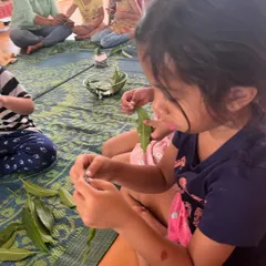 Children work with natural materials like leaves to create art. Summer camp is a great time to explore the beauty of the world around us.