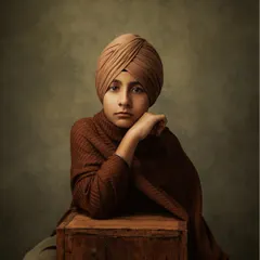 In color, the portrait takes on a warm, earthy feel. His expression is thoughtful and direct, a glimpse into the wise soul of this young man.
