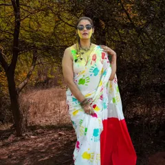 A stylish portrait from a Holi-themed fashion shoot. The colorful handprints on the saree create a unique and festive look, blending tradition with modern fashion sensibilities.