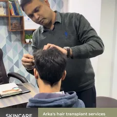 A crucial part of my process is the initial hair and scalp analysis. Here, I am examining a patient's scalp to understand the pattern and extent of hair loss. This detailed assessment allows me to recommend the most effective hair restoration treatment.