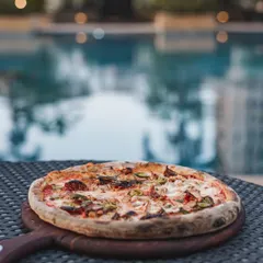 Pizza by the pool? Absolutely. Our mobile catering setup is versatile enough to bring the wood-fired experience to any location, turning your poolside party into a gourmet event.
