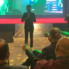 Taking a moment to connect with the audience after a stage illusion. The reactions and applause from a full house at a corporate gala are what make these large-scale shows so special.