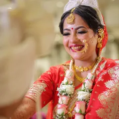 There is nothing more beautiful than a bride's genuine smile. Here is my gorgeous Bengali bride, Anamika, sharing a joyful moment during her wedding ceremony. I focused on a timeless look with a radiant base and classic red bindi.