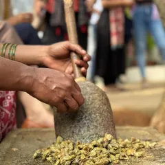 An artisan hand-grinds myrobalan, a natural tannin that helps fix color to fabric. We use traditional tools and methods, connecting us to the long history of natural dyeing in India.