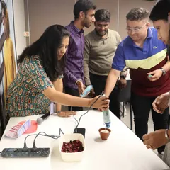 A participant gets hands-on experience, using a heat gun to ensure a smooth finish on their candle. Our workshops are interactive, allowing team members to learn and apply new crafting techniques.
