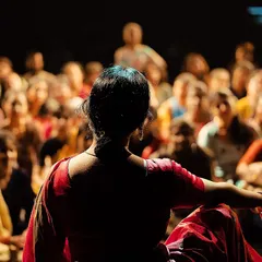 A powerful shot from behind the performer, capturing the rapt attention of the audience. This connection is why I build these stages. It is all for the community.