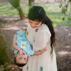 A playful, upside down view of the world for this happy baby, held securely in his mother's arms. We love capturing these spontaneous moments of fun during our outdoor shoots.