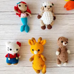 A collection of my cute crochet animal toys, including a mermaid, a sheep, Hello Kitty, a giraffe, and a teddy bear. They make wonderful, soft companions for little ones.