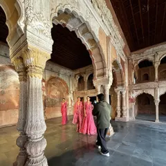 The reality of a campaign shoot. This wide shot shows the entire crew, lighting setup, and models in position, giving a true sense of the teamwork required to create the final images.