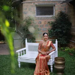 A serene bridal portrait. The makeup is kept classic and elegant, with an emphasis on radiant skin and defined features that enhance the bride's natural beauty in her stunning Kanjeevaram saree.