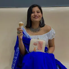Even an ice cream run can be a style moment. I love how my clutch adds an artistic touch to this casual, happy look, perfectly complementing the traditional jewelry and modern blouse.