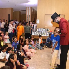 Getting the birthday boy involved in the magic is a key part of my show. Here, I'm sharing a special moment with Kavir, making him the star in front of his friends and family at his superhero-themed party.