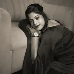A more intimate monochrome shot from Vidyasri's session. Leaning against the couch, her expression is soft yet direct. Removing color allows the focus to fall on her emotive eyes and the beautiful play of light and shadow on her face.