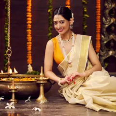 A direct-to-camera shot from the same traditional jewellery campaign. The model's warm smile and the beautifully arranged festive setting create an inviting and culturally rich image for the brand.