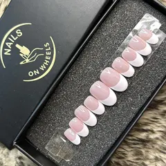 Another view of my classic oval-shaped French manicure set. This shows the consistent curve and finish across all the nails, which are sized to fit your natural nail bed perfectly.