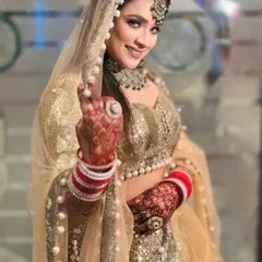 A happy bride in my dazzling gold sequin lehenga. The pearl-bordered dupatta adds a soft, classic touch to the modern sparkle of the outfit.