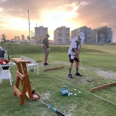Players practice their short game as the sun sets. Our facility is designed to be both functional and beautiful, offering a perfect escape.