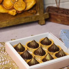 A box of nine of my signature chocolate modak tarts, ready for your Ganesh Chaturthi celebrations. The golden sheen on the chocolate makes them look as good as they taste.