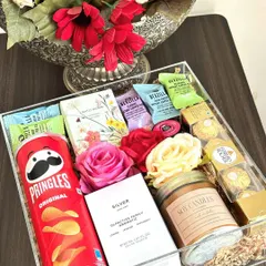 Our acrylic box hampers are perfect for any occasion. This one is customized for a couple, with "his and hers" Zara perfumes, Pringles, Ferrero Rocher, and a scented candle.
